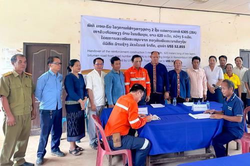 LXML Sepon Hands Bitumen Road to Nonesomboun Community, Vilabouly district.